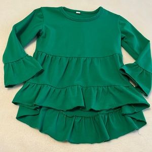 Lots of layers for this pretty green dress!
